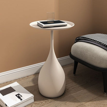 Rundt sidebord i metal med søjlefod, moderne minimalistisk design og robust jern
